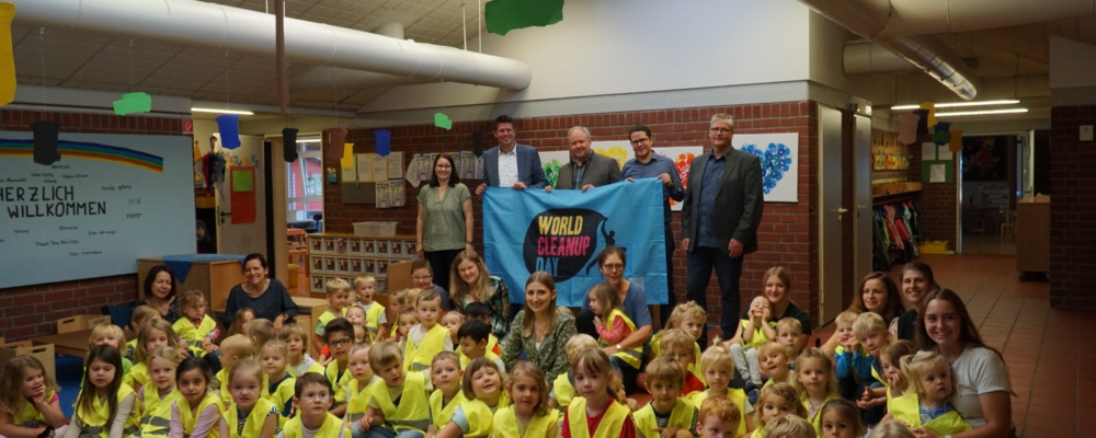 Kinder in Tageseinrichtung sitzen in Warnwesten